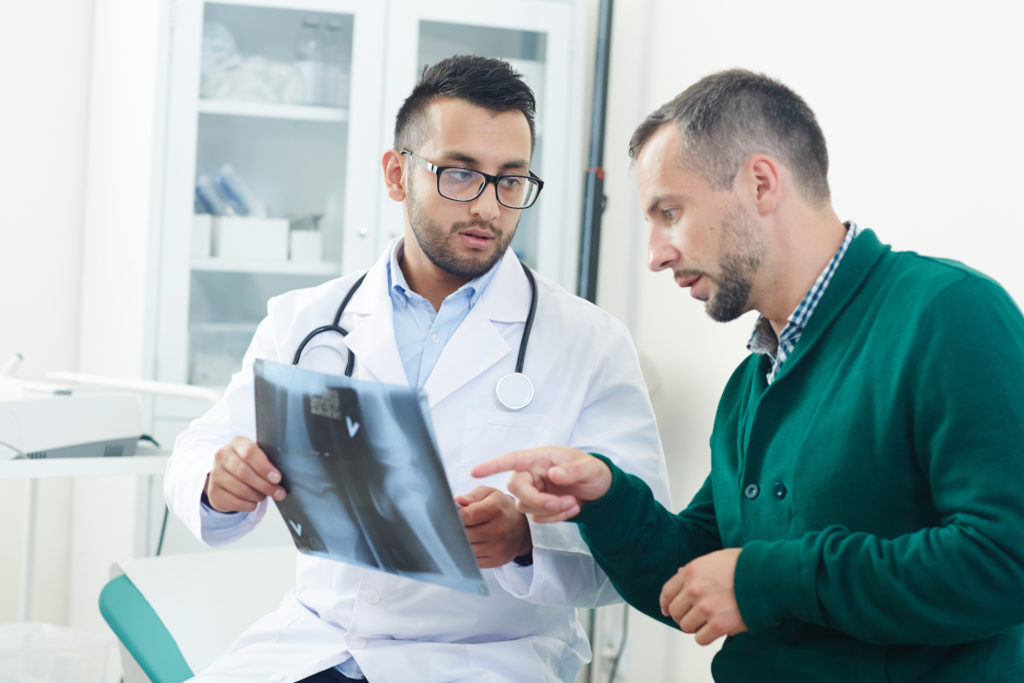 doctor and patient looking at x-ray result